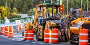 An off-duty police officer managing traffic at a busy construction site, ensuring safety for workers and the public.