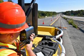 A police officer monitoring traffic near a construction zone to ensure safety and smooth flow of vehicles.